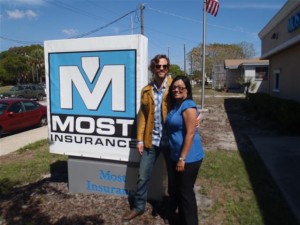 man and woman in front of Most Insurance outdoor sign