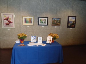 Most Insurance table with table cloth and paintings and flowers