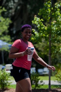 woman smiling and walking with purple hair and we heart FHR shirt