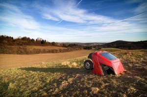 Rental Car Coverage red car in dirt field